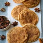 Freshly baked chai sugar cookies with spices and sugar on a cooling rack.