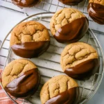 Delicious chocolate dipped peanut butter cookies on a baking tray