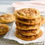 Freshly baked cinnamon chip cookies on a cooling rack.