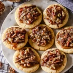 Delicious pecan pie cookies fresh from the oven, showcasing a golden brown texture.